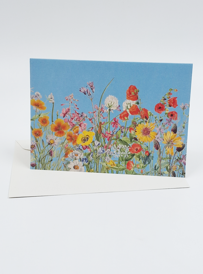 Wenskaart bloemen en blauwe lucht