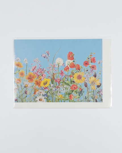 Wenskaart bloemen en blauwe lucht